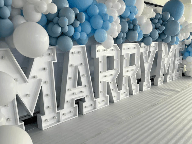 Marry Me custom signage and balloons to match