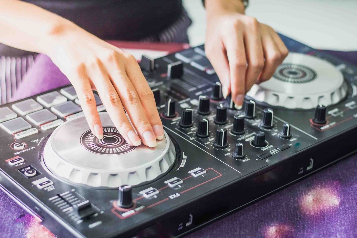 DJ controller with audio mixing turntable and customers who come to listen to each other happily.